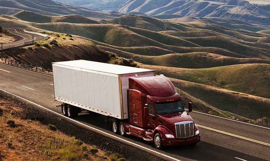 red-semi-truck-dry-van-trailer-badlands
