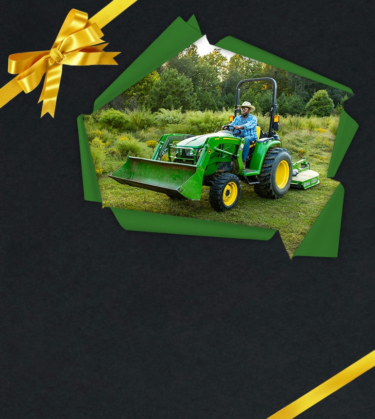 Lawn tractor with loader attachment in field, surrounded by a gift wrapping border.