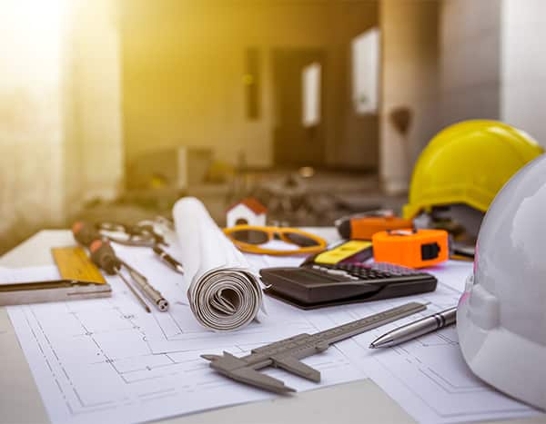 blueprints and construction supplies on a table