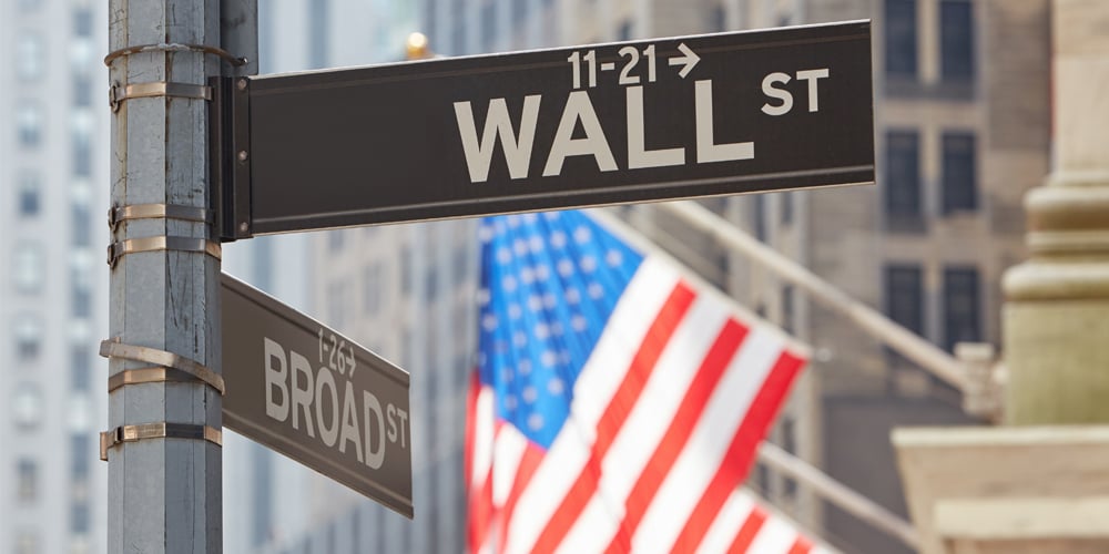 Wall Street sign with American flags in the background