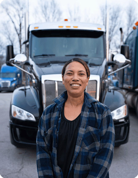 Female truck driver standing in front of semi truck