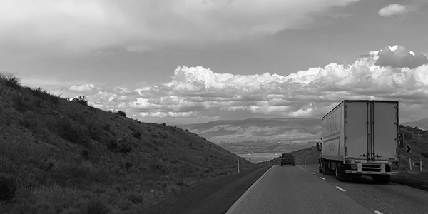 Semi truck driving down highway