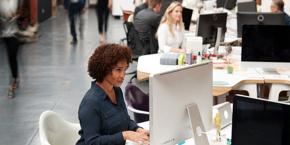People working in an open floor, modern office.