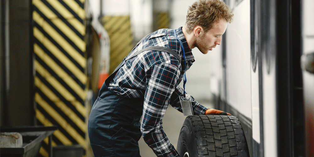 Man putting on tire.