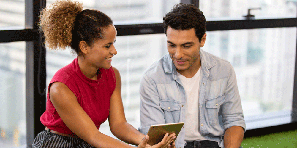 Man and woman viewing a tablet screen together.