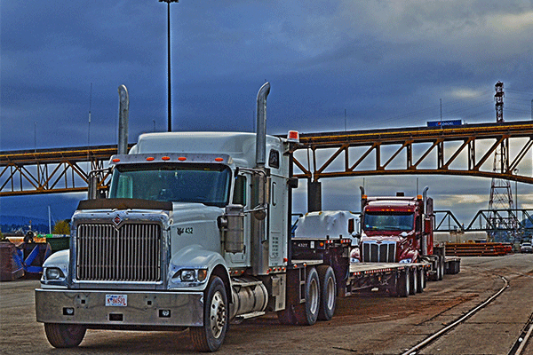 three semi trucks crossing the international border