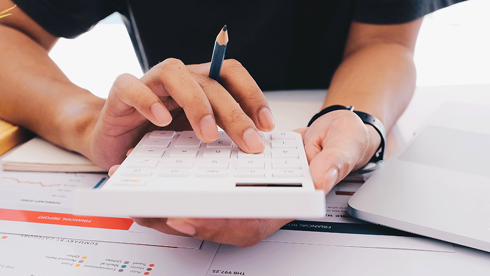 Woman-Calculating-Expenses-Using-Calculator