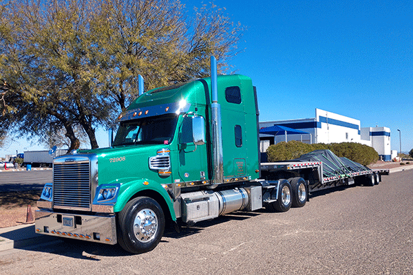 Step deck trailer hauling freight