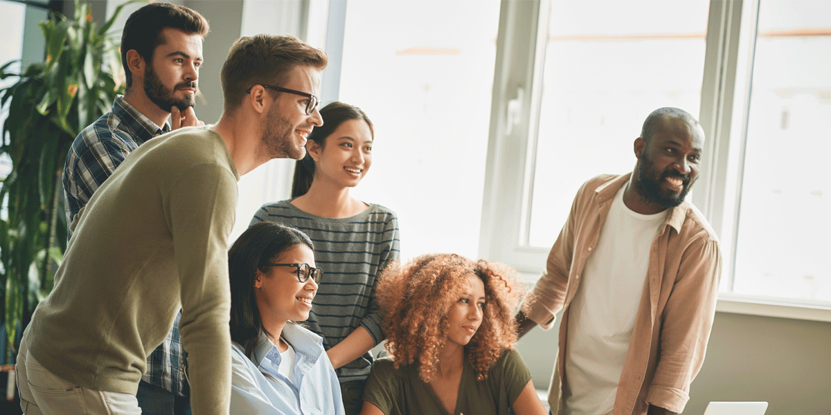 TeamGatheredAtDeskFeatured