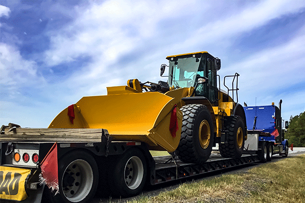Construction equipment on trailer flatbed